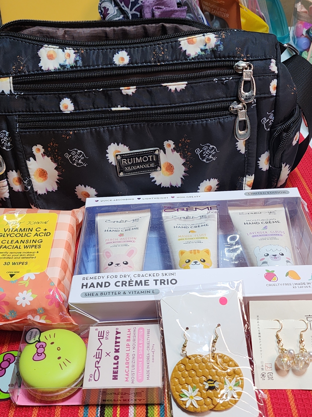 Floral Purse Creme Lotion and lip balm.Earrings Betsy Johnson face wipes